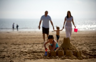 Family strolling on beach